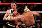 NEW YORK - MAY 15:  Amir Khan (R) of Great Britain hits Paulie Malignaggi during the WBA light welterweight title fight at Madison Square Garden on May 15, 2010 in New York City.  (Photo by Chris Trotman/Getty Images)