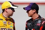 BRISTOL, TN - MARCH 19:  Kyle Busch (L), driver of the #18 M&M's Toyota, talks with Denny Hamlin, driver of the #11 FedEx Toyota, during qualifying for the NASCAR Sprint Cup Series Food City 500 at Bristol Motor Speedway on March 19, 2010 in Bristol, Tennessee.  (Photo by Geoff Burke/Getty Images for NASCAR)