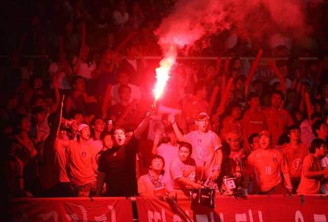ANSAN, SOUTH KOREA - JULY 16:  South Korean fans celebrate after score during the international friendly match between South Korea U-23 and Guatemala national team at Ansan-Wa  stadium on July 16, 2008 in Ansan, South Korea. South Korea won 2:1.  (Photo by Chung Sung-Jun/Getty Images)