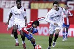 MADRID, SPAIN - OCTOBER 31:  Sergio 'Kun' Aguero of Atletico de Madrid falls between Seydou Keita (L) and  Khalid Boulahrouz of Sevilla during the Primera Liga match between Atletico de Madrid and Sevilla at the Vicente Calderon stadium on October 31, 2007 in Madrid, Spain.  (Photo by Denis Doyle/Getty Images)