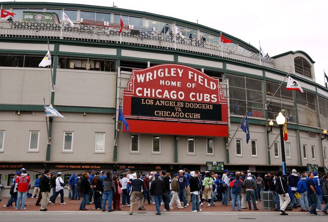 CHICAGO - OCTOBER 01:  Fans stand outside Wrigley Field under the famous marquee, which reads Los Angeles Dodgers vs. Chicago Cubs' prior to the Cubs hosting the Dodgers in Game One of the NLDS during the 2008 MLB Playoffs at Wrigley Field on October 1, 2008 in Chicago, Illinois.  (Photo by Jamie Squire/Getty Images)