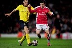 LONDON, ENGLAND - MARCH 31:  Cesc Fabregas of Arsenal is tackled by Sergio Busquets (L) of Barcelona during the UEFA Champions League quarter final first leg match between Arsenal and FC Barcelona at the Emirates Stadium on March 31, 2010 in London, England.  (Photo by Shaun Botterill/Getty Images)