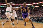 BOSTON - JANUARY 31:  Kobe Bryant  #24 of the Los Angeles Lakers drives to the basket against the defense of  Rajon Rondo #9 of the Boston Celtics in the second half at the TD Garden on January 31, 2010 in Boston, Massachusetts.  The Lakers won 90-89. NOTE TO USER: User expressly acknowledges and agrees that, by downloading and or using this photograph, User is consenting to the terms and conditions of the Getty Images License Agreement. (Photo by Jim Rogash /Getty Images)