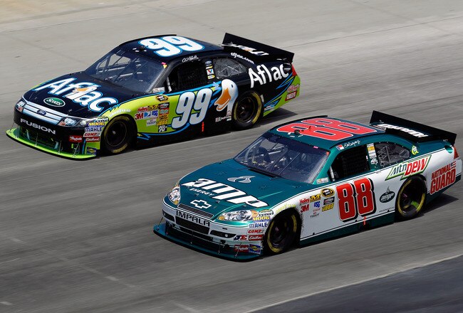 DOVER, DE - MAY 16: Carl Edwards, driver of the #99 Aflac Ford, and Dale Earnhardt Jr., driver of the #88 AMP Energy/National Guard Chevrolet, race side by side during the NASCAR Sprint Cup Series Autism Speaks 400 at Dover International Speedway on May 16, 2010 in Dover, Delaware.  (Photo by Todd Warshaw/Getty Images)