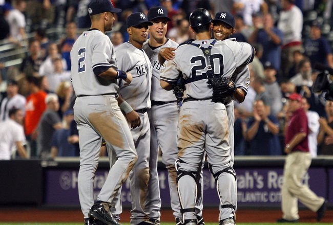 NEW YORK - JUNE 28:  Mariano Rivera #42 of the New York Yankees celebrates with teammates Jorge Posada #20, Mark Teixeira #25 (C), Robinson Cano #24, and Derek Jeter #2 after the final out against the New York Mets on June 28, 2009 at Citi Field in the Flushing neighborhood of the Queens borough of New York City. The Yankees defeated the Mets 4-2 and Yankee pitcher Mariano Rivera recorded his 500th career save.  (Photo by Jim McIsaac/Getty Images)