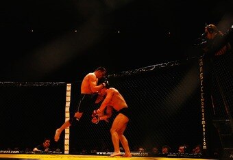 LONDON - FEBRUARY 10:  Marios Zaromskis lands a kick to the face of opponent Damien Riccio during the Cage Rage Championship 20 Born to fight event at Wembley Arena on February 10, 2007 in London, England. Cage Fighting also known as MMA Mixed Martial Arts is a mixed fighting style combat sport with a steadily growing international fan base. MMA is an evolving combat sport where competitors combine different disciplines that include jiu-jitsu, judo, karate, boxing, kickboxing, wrestling and others to their strategic and tactical advantage in a competetive arena.  (Photo by Daniel Berehulak/Getty Images)