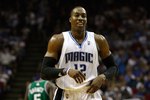 ORLANDO, FL - MAY 18:  Dwight Howard #12 of the Orlando Magic smiles as he looks on against the Boston Celtics in Game Two of the Eastern Conference Finals during the 2010 NBA Playoffs at Amway Arena on May 18, 2010 in Orlando, Florida.  NOTE TO USER: User expressly acknowledges and agrees that, by downloading and/or using this Photograph, user is consenting to the terms and conditions of the Getty Images License Agreement.  (Photo by Doug Benc/Getty Images)