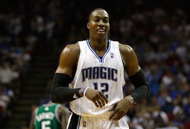 ORLANDO, FL - MAY 18:  Dwight Howard #12 of the Orlando Magic smiles as he looks on against the Boston Celtics in Game Two of the Eastern Conference Finals during the 2010 NBA Playoffs at Amway Arena on May 18, 2010 in Orlando, Florida.  NOTE TO USER: User expressly acknowledges and agrees that, by downloading and/or using this Photograph, user is consenting to the terms and conditions of the Getty Images License Agreement.  (Photo by Doug Benc/Getty Images)