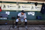 OAKLAND, CA - APRIL 08:  Ichiro Suzuki #51 of the Seattle Mariners warms up in the dugout against the Oakland Athletics during an MLB game at the Oakland-Alameda County Coliseum on April 8, 2010 in Oakland, California.  (Photo by Jed Jacobsohn/Getty Images)