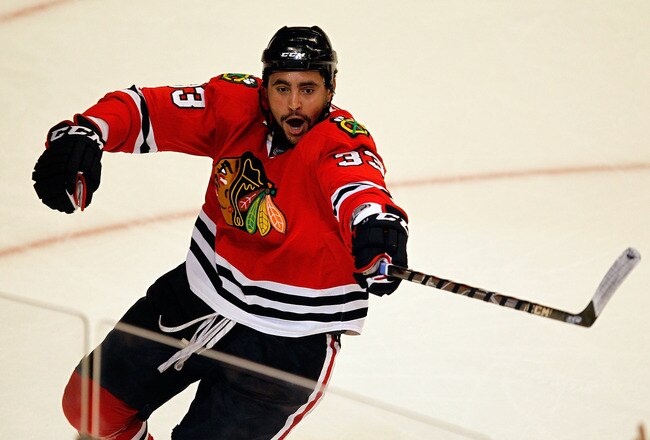 CHICAGO - MAY 23:  Dustin Byfuglien #33 of the Chicago Blackhawks celebrates his third period goal while taking on the San Jose Sharks in Game Four of the Western Conference Finals during the 2010 NHL Stanley Cup Playoffs at the United Center on May 23, 2010 in Chicago, Illinois.  (Photo by Jonathan Daniel/Getty Images)
