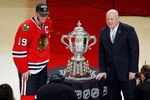 CHICAGO - MAY 23:  Jonathan Toews #19 of the Chicago Blackhawks poses with National Hockey League Deputy Commissioner Bill Daly as Toews receives the Campbell Trophy for winning the Western Conference after the Blackhawks 4-2 victory in Game Four of the Western Conference Finals during the 2010 NHL Stanley Cup Playoffs at the United Center on May 23, 2010 in Chicago, Illinois.  (Photo by Jonathan Daniel/Getty Images)