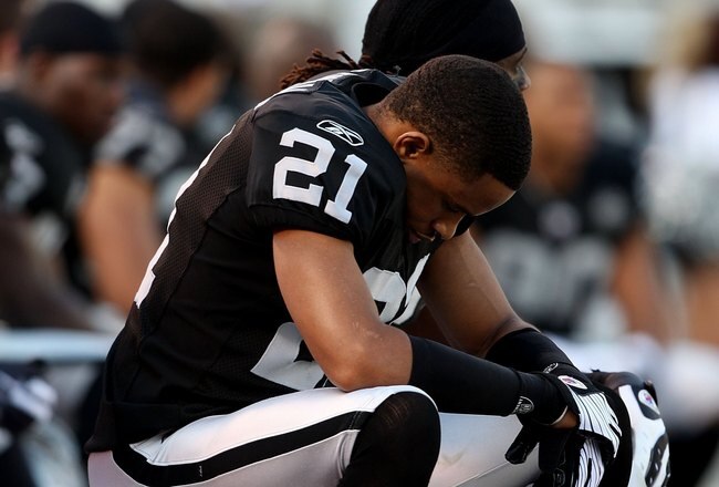 OAKLAND, CA - JANUARY 03:  Nnamdi Asomugha #21 of the Oakland Raiders sits on the bench against the Baltimore Ravens during an NFL game at Oakland-Alameda County Coliseum on January 3, 2010 in Oakland, California.  (Photo by Jed Jacobsohn/Getty Images)