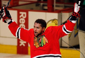 CHICAGO - MAY 21:  Dustin Byfuglien #33 of the Chicago Blackhawks greets the fans after scoring the game-winning goal in overtime to defeat the San Jose Sharks 3-2 in Game Three of the Western Conference Finals during the 2010 NHL Stanley Cup Playoffs at the United Center on May 21, 2010 in Chicago, Illinois.  (Photo by Jonathan Daniel/Getty Images)