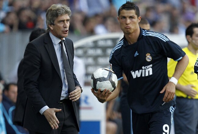 MALAGA, SPAIN - MAY 16: Head coach Manuel Pellegrini (L) gives instructions to Cristiano Ronaldo during the La Liga match between Malaga and Real Madrid at La Rosaleda Stadium on May 16, 2010 in Malaga, Spain. (Photo by Angel Martinez/Getty Images)