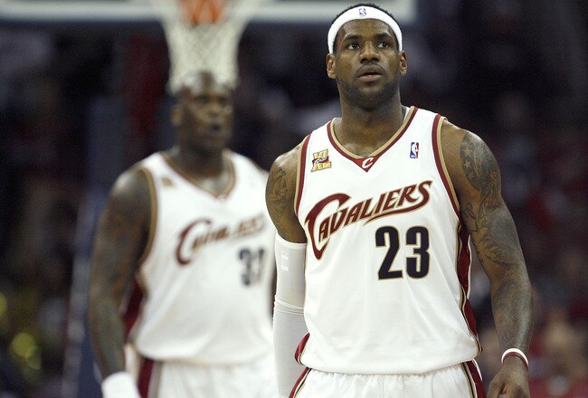 CLEVELAND - APRIL 17:  LeBron James #23 of the Cleveland Cavaliers looks on in front of teammate Shaquille O'Neal #33 while playing the Chicago Bulls in Game One of the Eastern Conference Quarterfinals during the 2010 NBA Playoffs at Quicken Loans Arena on April 17, 2010 in Cleveland, Ohio. Cleveland won the game 96-83 to take a 1-0 series lead. NOTE TO USER: User expressly acknowledges and agrees that, by downloading and or using this photograph, User is consenting to the terms and conditions of the Getty Images License Agreement.  (Photo by Gregory Shamus/Getty Images)