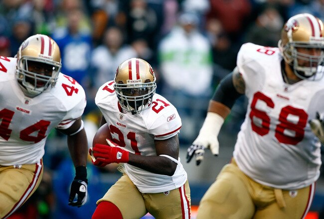 SEATTLE , WA - DECEMBER 06:  Frank Gore #21 of the San Francisco 49ers runs behind his blockers Morgan Norris #44 and Adam Spencer #68 against the Seattle Seahawks at Qwest Field on December 6, 2009 in Seattle, Washington.  (Photo by Jonathan Ferrey/Getty Images)