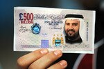 MANCHESTER, UNITED KINGDOM - SEPTEMBER 13:  A Manchester City fan holds a fake British Pound note with the face of Dr Sulaiman Al Fahim during the Barclays Premier League match between Manchester City and Chelsea at The City of Manchester Stadium on September 13, 2008 in Manchester, England.  (Photo by Shaun Botterill/Getty Images)