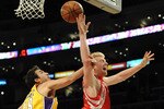 LOS ANGELES, CA - JANUARY 05:  Chase Budinger #10 of the Houston Rockets is fouled on a layup by Sasha Vujacic #18 of the Los Angeles Lakers during the second half at Staples Center on January 5, 2010 in Los Angeles, California.  NOTE TO USER: User expressly acknowledges and agrees that, by downloading and/or using this Photograph, user is consenting to the terms and conditions of the Getty Images License Agreement.  (Photo by Harry How/Getty Images)