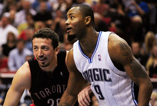 ORLANDO, FL - DECEMBER 16:  Hedo Turkoglu #26 of the Toronto Raptors guards Rashard Lewis #9 of the Orlando Magic during the game at Amway Arena on December 16, 2009 in Orlando, Florida.  NOTE TO USER: User expressly acknowledges and agrees that, by downloading and/or using this Photograph, user is consenting to the terms and conditions of the Getty Images License Agreement.  (Photo by Sam Greenwood/Getty Images)