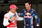 ISTANBUL, TURKEY - MAY 29:  Pole sitter Mark Webber (R) of Australia and Red Bull Racing celebrates in parc ferme with second placed Lewis Hamilton (L) of Great Britain and McLaren Mercedes after qualifying for the Turkish Formula One Grand Prix at Istanbul Park on May 29, 2010, in Istanbul, Turkey.  (Photo by Malcolm Griffiths/Getty Images)