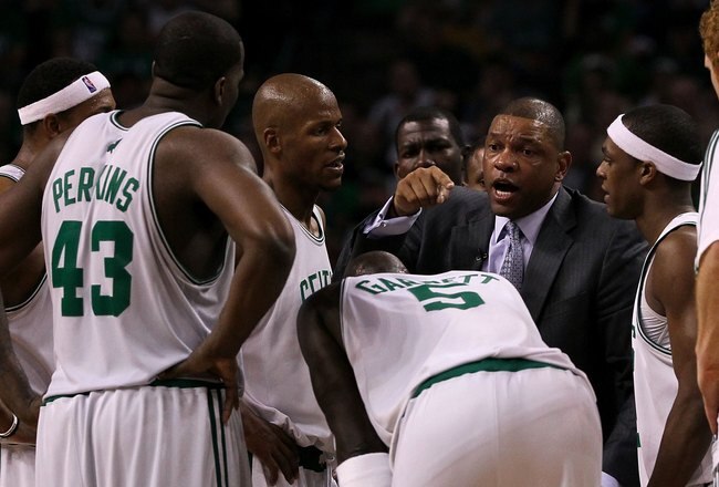 BOSTON - MAY 28:  Head coach Doc Rivers of the Boston Celtics talks with his players during a timeout against the Orlando Magic in Game Six of the Eastern Conference Finals during the 2010 NBA Playoffs at TD Garden on May 28, 2010 in Boston, Massachusetts.  NOTE TO USER: User expressly acknowledges and agrees that, by downloading and/or using this Photograph, user is consenting to the terms and conditions of the Getty Images License Agreement.  (Photo by Jim Rogash/Getty Images)