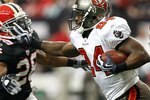 ATLANTA - NOVEMBER 29:  Cadillac Williams #24 of the Tampa Bay Buccaneers stiff arms Erik Coleman #26 of the Atlanta Falcons at Georgia Dome on November 29, 2009 in Atlanta, Georgia.  (Photo by Kevin C. Cox/Getty Images)