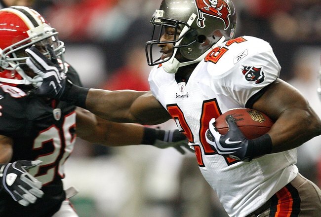 ATLANTA - NOVEMBER 29:  Cadillac Williams #24 of the Tampa Bay Buccaneers stiff arms Erik Coleman #26 of the Atlanta Falcons at Georgia Dome on November 29, 2009 in Atlanta, Georgia.  (Photo by Kevin C. Cox/Getty Images)