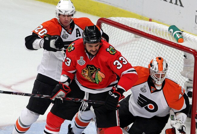 CHICAGO - MAY 31:  Dustin Byfuglien #33 of the Chicago Blackhawks fights for position against Chris Pronger #20 and Michael Leighton #49 of the Philadelphia Flyers in Game Two of the 2010 NHL Stanley Cup Final at the United Center on May 31, 2010 in Chicago, Illinois.  (Photo by Bruce Bennett/Getty Images)