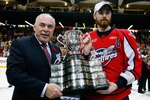 BRANDON, CANADA - MAY 23: CHL Commisioner David Branch awards the Memorial Cup to Harry Young #55 of the Windsor Spitfires after the Windsor Spitfires defeated the Brandon Wheat Kings in the Final of the 2010 Mastercard Memorial Cup Tournament at the Keystone Centre on May 1, 2010 in Brandon, Manitoba, Canada. (Photo by Richard Wolowicz/Getty Images)