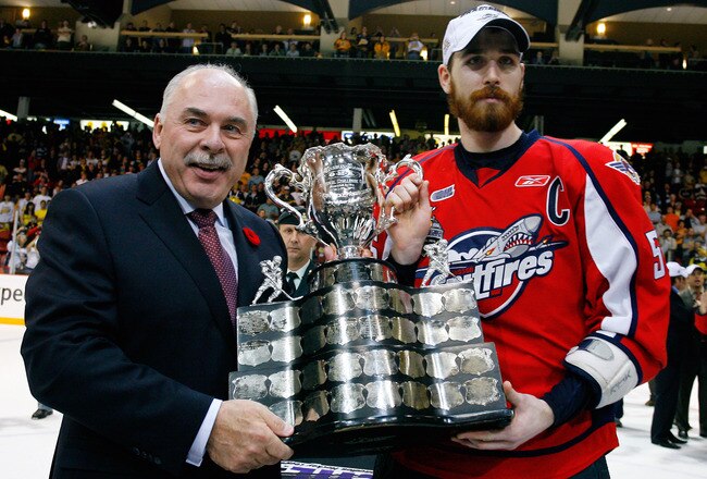 BRANDON, CANADA - MAY 23: CHL Commisioner David Branch awards the Memorial Cup to Harry Young #55 of the Windsor Spitfires after the Windsor Spitfires defeated the Brandon Wheat Kings in the Final of the 2010 Mastercard Memorial Cup Tournament at the Keystone Centre on May 1, 2010 in Brandon, Manitoba, Canada. (Photo by Richard Wolowicz/Getty Images)