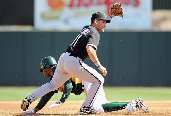 PHOENIX - MARCH 10:  Rajai Davis #11 of the Oakland Athletics safely steals second base past infielder Omar Vizquel #11 of the Chicago White Sox during the MLB spring training game at Phoenix Municipal Stadium on March 10, 2010 in Phoenix, Arizona. The White Sox defeated the A's 9-5.  (Photo by Christian Petersen/Getty Images)