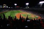BOSTON - OCTOBER 13:  The crowd cheers as Mike Lowell #25 of the Boston Red Sox hits a two RBI single in the third inning during Game Two of the American League Championship Series against the Cleveland Indians at Fenway Park on October 13, 2007 in Boston, Massachusetts.  (Photo by Al Bello/Getty Images)