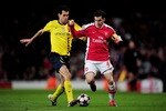 LONDON, ENGLAND - MARCH 31:  Cesc Fabregas of Arsenal is tackled by Sergio Busquets (L) of Barcelona during the UEFA Champions League quarter final first leg match between Arsenal and FC Barcelona at the Emirates Stadium on March 31, 2010 in London, England.  (Photo by Shaun Botterill/Getty Images)