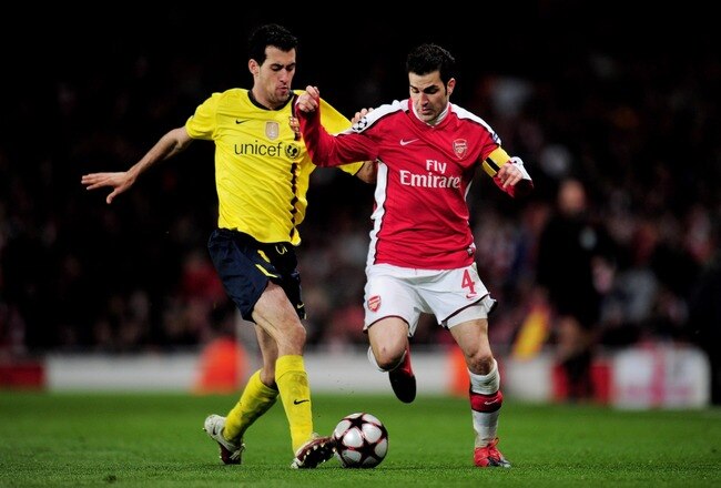 LONDON, ENGLAND - MARCH 31:  Cesc Fabregas of Arsenal is tackled by Sergio Busquets (L) of Barcelona during the UEFA Champions League quarter final first leg match between Arsenal and FC Barcelona at the Emirates Stadium on March 31, 2010 in London, England.  (Photo by Shaun Botterill/Getty Images)