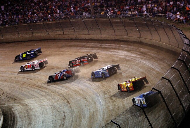 ROSSBURG, OH - SEPTEMBER 09:  Jimmie Johnson, driver of the #48 leads Tony Stewart, driver of the #14 through turn four during the heat races before the Gillette Young Guns Prelude to the Dream at Eldora Speedway on September 9, 2009 in Rossburg, Ohio.  (Photo by Chris Graythen/Getty Images for True Speed Communication)
