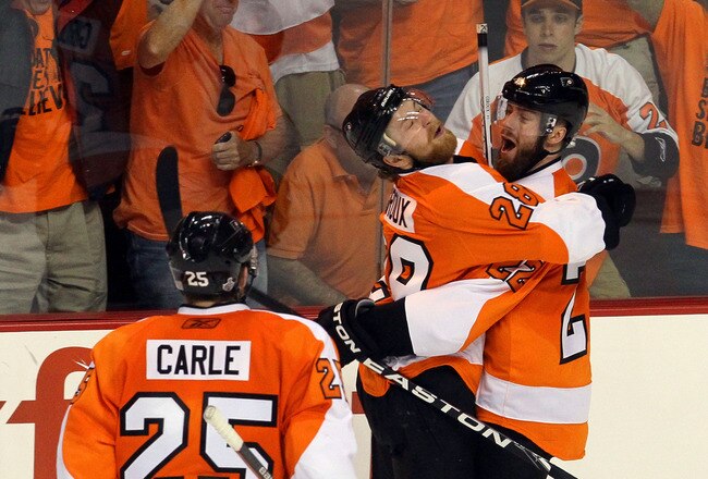 PHILADELPHIA - JUNE 02:  Ville Leino #22 of the Philadelphia Flyers celebrates with teammates Matt Carle #25 and Claude Giroux #28 after scoring a goal in the third period against the Chicago Blackhawks in Game Three of the 2010 NHL Stanley Cup Final at Wachovia Center on June 2, 2010 in Philadelphia, Pennsylvania.  (Photo by Jim McIsaac/Getty Images)