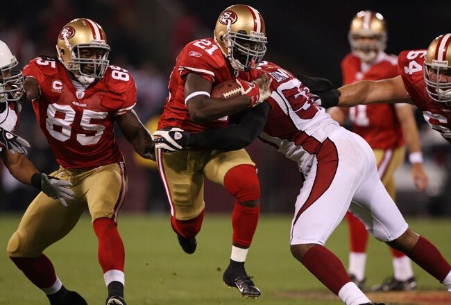 SAN FRANCISCO - DECEMBER 14:  Running back Frank Gore #21 of the San Francisco 49ers runs the ball as he is hit by Karlos Dansby #58 of the Arizona Cardinals in the first quarter at Candlestick Park on December 14, 2009 in San Francisco, California. (Photo by Jed Jacobsohn/Getty Images)