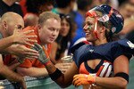 HOFFMAN ESTATES, IL - SEPTEMBER 04:  Kate Johns of the Chicago Bliss greets fans following the Bliss' defeat of the Miami Caliente during the opening game of the Lingerie Football League (LFL) at the Sears Centre Arena September 4, 2009 in Hoffman Estates, Illinois. The LFL is a female football league with ten teams that compete in seven-on-seven full-contact American football, with players dressed in sports bras and short shorts.  (Photo by Scott Olson/Getty Images)