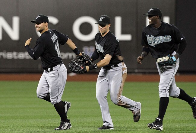 NEW YORK - APRIL 08:  (L-R) Cody Ross #12, Chris Coghlan #8, and Cameron Maybin #24 of the Florida Marlins celebrate after defeating the New York Mets on April 8, 2010 at Citi Field in the Flushing neighborhood of the Queens borough of New York City.  (Photo by Jim McIsaac/Getty Images)