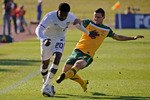 ROODEPOORT, SOUTH AFRICA - JUNE 05: Robbie Findley #20 of USA is tackled by Jason Culina #5 of Australia during first half of the 2010 FIFA World Cup Pre-Tournament match between the Australian Socceroos and the United States of America at Ruimsig Stadium on June 5, 2010 in Roodepoort, South Africa. USA won, 3-1.  (Photo by Kevork Djansezian/Getty Images)