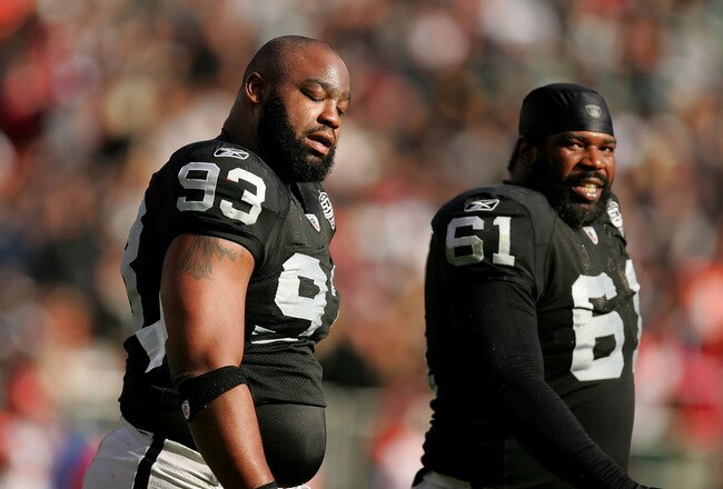 OAKLAND, CA - NOVEMBER 22:  Tommy Kelly #93 and Gerard Warren #61 of the Oakland Raiders react after the Cincinnati Bengals scored a touchdown at Oakland-Alameda County Coliseum on November 22, 2009 in Oakland, California.  (Photo by Ezra Shaw/Getty Images)