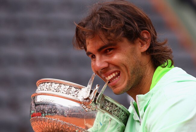PARIS - JUNE 06:  Rafael Nadal of Spain celebrates with the trophy after winning the men's singles final match between Rafael Nadal of Spain and Robin Soderling of Sweden on day fifteen of the French Open at Roland Garros on June 6, 2010 in Paris, France.  (Photo by Julian Finney/Getty Images)
