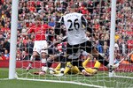 LONDON, ENGLAND - MAY 09:  Andre Arshavin of Arsenal threads the ball past Mark Schwarzer of Fulham and Chris Smalling of Fulham (26) to score Arsenal's first goal during the Barclays Premier League match between Arsenal and Fulham at The Emirates Stadium on May 9, 2010 in London, England.  (Photo by David Cannon/Getty Images)