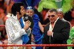 LAS VEGAS - AUGUST 24:  An Elvis Presley impersonator sings to World Wrestling Entertainment Inc. Chairman Vince McMahon during his 64th birthday celebration in the ring during the WWE Monday Night Raw show at the Thomas & Mack Center August 24, 2009 in Las Vegas, Nevada.  (Photo by Ethan Miller/Getty Images)