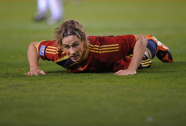 LA CORUNA, SPAIN - SEPTEMBER 05:  Fernando Torres of Spain takes a knock during the Group 5 FIFA2010 World Cup Qualifier match between Spain and Belgium at the Riazor stadium on September 5, 2009 in La Coruna, Spain.  (Photo by Denis Doyle/Getty Images)