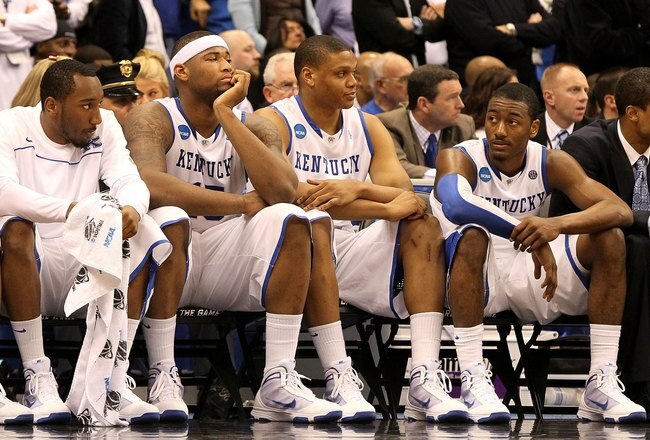 SYRACUSE, NY - MARCH 27:  (L-R) Ramon Harris #5, DeMarcus Cousins #15, Daniel Orton #33 and John Wall #11 of the Kentucky Wildcats look on dejected from the bench in the final minute of the second half against the West Virginia Mountaineers during the east regional final of the 2010 NCAA men's basketball tournament at the Carrier Dome on March 27, 2010 in Syracuse, New York. West Virginia won 73-66. (Photo by Jim McIsaac/Getty Images)