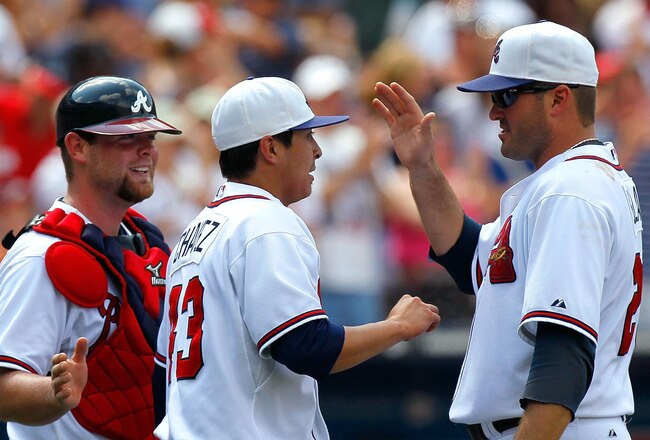 ATLANTA - MAY 31:  Catcher Brian McCann #16 and Troy Glaus #25 of the Atlanta Braves congratulate closer Jesse Chavez #43 after their 9-3 win over the Philadelphia Phillies at Turner Field on May 31, 2010 in Atlanta, Georgia.  (Photo by Kevin C. Cox/Getty Images)