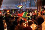 JOHANNESBURG, SOUTH AFRICA - JUNE 08:  Primary school children wave the South African flag while performing in a play to celebrate the soccer World Cup on June 8, 2010 in Johannesburg, South Africa. Jewish children from the King David Victory Park Primary School completed their final dress rehersal before performing in two sold out shows highlighting South African enthusiasm for the World Cup, which begins Friday.  (Photo by John Moore/Getty Images)