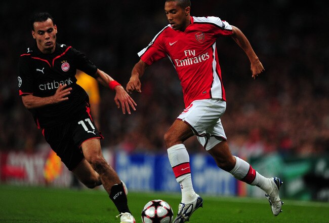 LONDON, ENGLAND - SEPTEMBER 29: Gael Clichy of Arsenal runs with the ball as Jaouad Zairi of Olympiakos defends during the UEFA Champions League Group H match between Arsenal and Olympiakos at the Emirates Stadium on September 29, 2009 in London, England.  (Photo by Mike Hewitt/Getty Images)