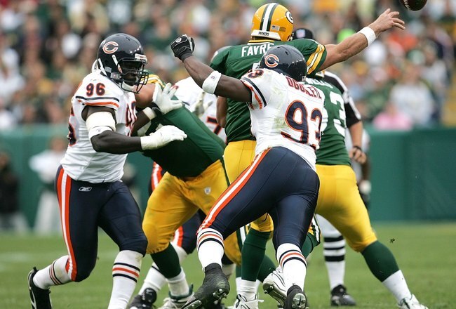 GREEN BAY, WI - SEPTEMBER 10: Brett Favre #4 of the Green Bay Packers throws a pass under pressure from Alex Brown #96 and Adewale Ogunleye #93 of the Chicago Bears on September 10, 2006 at Lambeau Field in Green Bay, Wisconsin. The Bears defeated the Packers 26-0. (Photo by Jonathan Daniel/Getty Images)